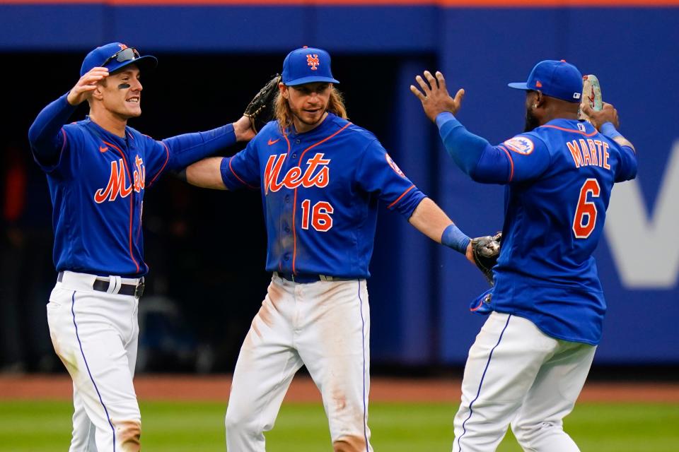 New York Mets players, from left, Mark Canha, Travis Jankowski and Starling Marte celebrate after defeating the Atlanta Braves in the the first baseball game of a doubleheader, Tuesday, May 3, 2022, in New York. The Mets won 5-4.