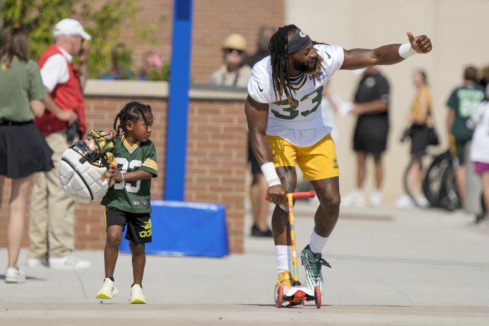 Green Bay Packers' Aaron Jones rides a scooter to NFL football training camp Thursday, July 27, 2023, in Green Bay, Wis. (AP Photo/Morry Gash)