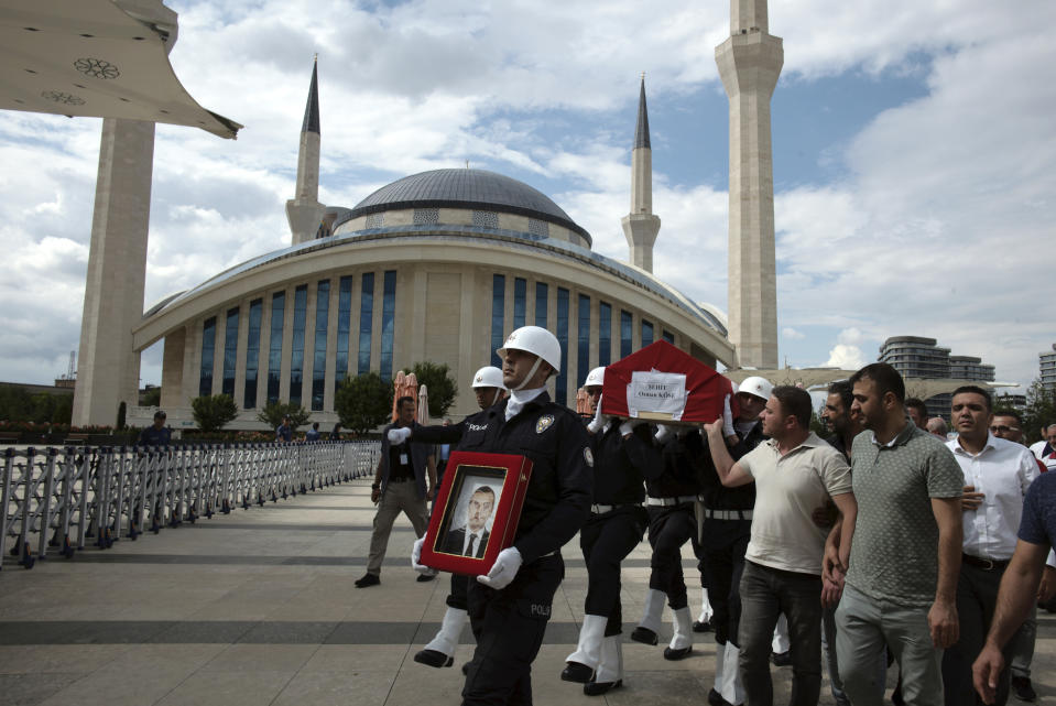 A police honour guard carry the coffin of Osman Kose, a 38-year-old Turkish diplomat killed in Iraq, before his funeral prayers in Ankara, Turkey, Thursday, July 18, 2019. A gunman opened fire inside a restaurant in the northern Iraqi city of Irbil on Wednesday, killing a Turkish diplomat working at Ankara's consulate, Turkey's state-run news agency and Iraqi media said.(AP Photo/Burhan Ozbilici)