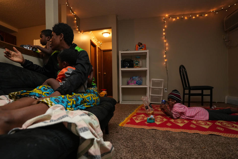 Mawazo Ilanga eats an after-school snack while her mom Mariamu Bahome holds her youngest son Bahome Ilanga at their home at Hickman Loft Apartments.