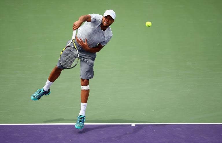 Jo-Wilfried Tsonga of France serves against Tim Smyczek of the United States during the Miami Open on March 28, 2015 in Key Biscayne, Florida