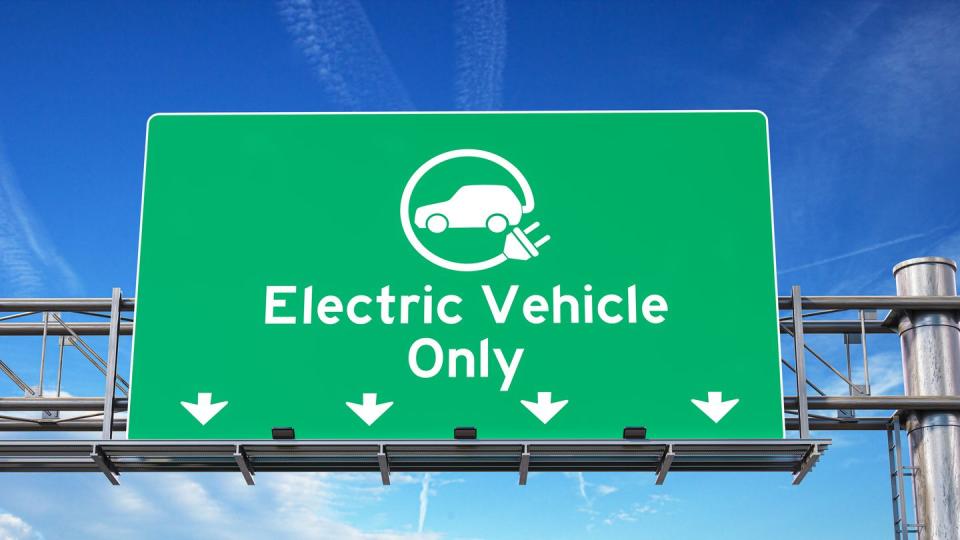 electric vehicle only green traffic road sign with symbol of electric car on sky background ecology and environmental concept background
