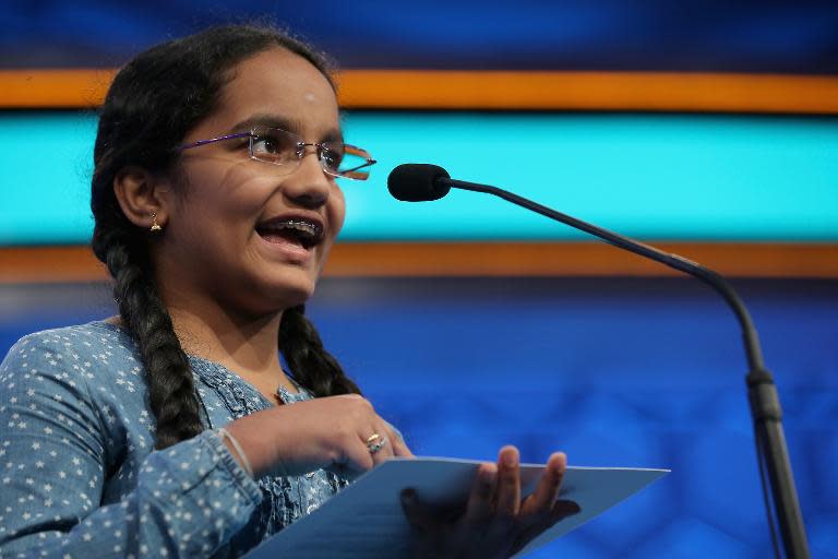 Sai Vishudhi Chandrasekhar (L) of New York, New York, spells a word correctly during the 88th Scripps National Spelling Bee semifinals at the Gaylord National Convention Center May 28, 2015 in Washington, DC