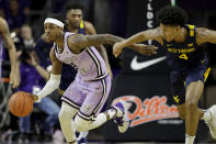 Kansas State's Cartier Diarra (2) drives past West Virginia's Miles McBride (4) during the second half of an NCAA college basketball game Saturday, Jan. 18, 2020 in Lawrence, Kan. Kansas State won 84-68. (AP Photo/Charlie Riedel)