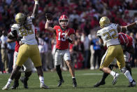 Georgia quarterback Stetson Bennett (13) throws a pass during the first half of an NCAA college football game against Georgia Tech, Saturday, Nov. 26, 2022 in Athens, Ga. (AP Photo/John Bazemore)