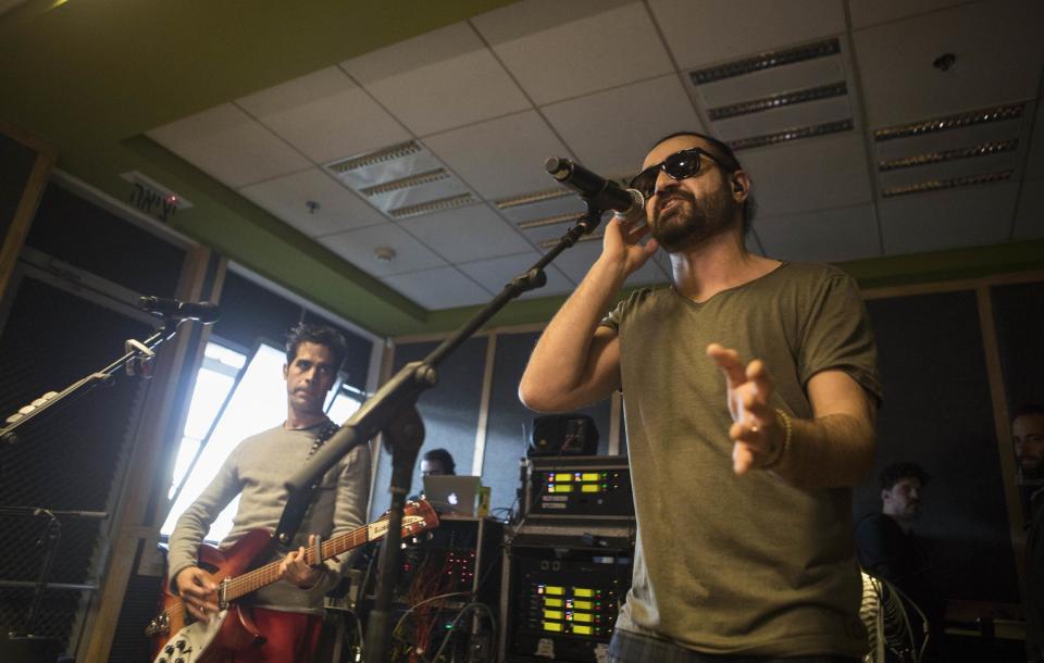 In this Monday, Feb. 27, 2017 photo, Iranian Shahin Najafi, right, and Israeli Aviv Geffen singers rehearse in Tel Aviv, Israel. In a first joint Israeli-Iranian concert, the rockers hope to prove that despite the bitter enmity between their countries the people can unite in the name of a better future. Geffen and Najafi say their Hebrew-Farsi fusion offers hope in a volatile region. (AP Photo/Dan Balilty)