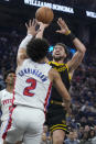 Golden State Warriors guard Klay Thompson, right, shoots against Detroit Pistons guard Cade Cunningham (2) during the first half of an NBA basketball game in San Francisco, Friday, Jan. 5, 2024. (AP Photo/Jeff Chiu)
