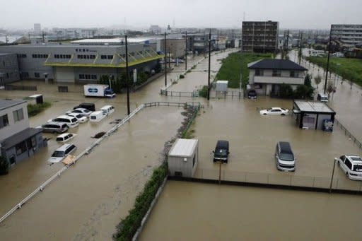 Vehicles sit submerged in floodwaters in Nagoya, Aichi prefecture, in central Japan. More than a million people in Japan were warned to leave their homes on Tuesday as an approaching typhoon brought heavy rain and floods which left three dead or missing