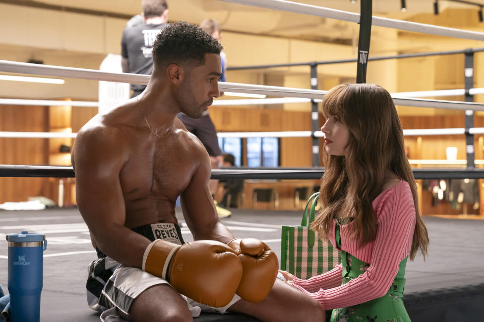 Lucien Laviscount and Lily Collins at a boxing ring in Emily in Paris season 4