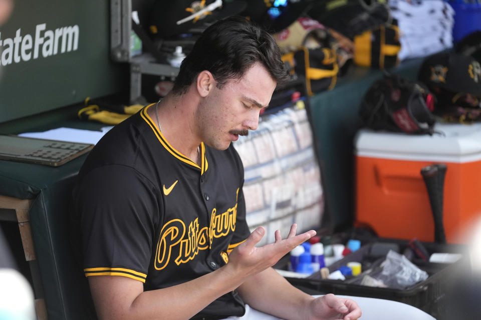 Pittsburgh Pirates starting pitcher Paul Skenes looks over his pitching hand in the dugout during the fifth inning of a baseball game against the Chicago Cubs Friday, May 17, 2024, in Chicago. (AP Photo/Charles Rex Arbogast)