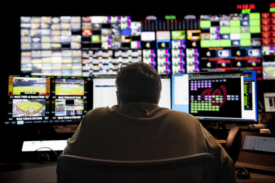 Employees operate workstations during a tour inside the broadcast support room at Major League Baseball headquarters in New York, Tuesday, March 28, 2023. (AP Photo/John Minchillo)