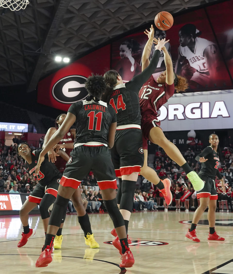 South Carolina Brea Beal (12) shoots over Georgia's Maya Caldwell (11) and Jenna Staiti (14) during the first half of an NCAA college basketball game Sunday, Jan. 26, 2020, in Athens, Ga. (AP Photo/Tami Chappell)