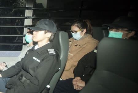 Law Wan-tung (C), former employer of Indonesian domestic helper Erwiana Sulistyaningsih, sits in a prison van as she arrives to the district court in Hong Kong February 27, 2015. REUTERS/Tyrone Siu