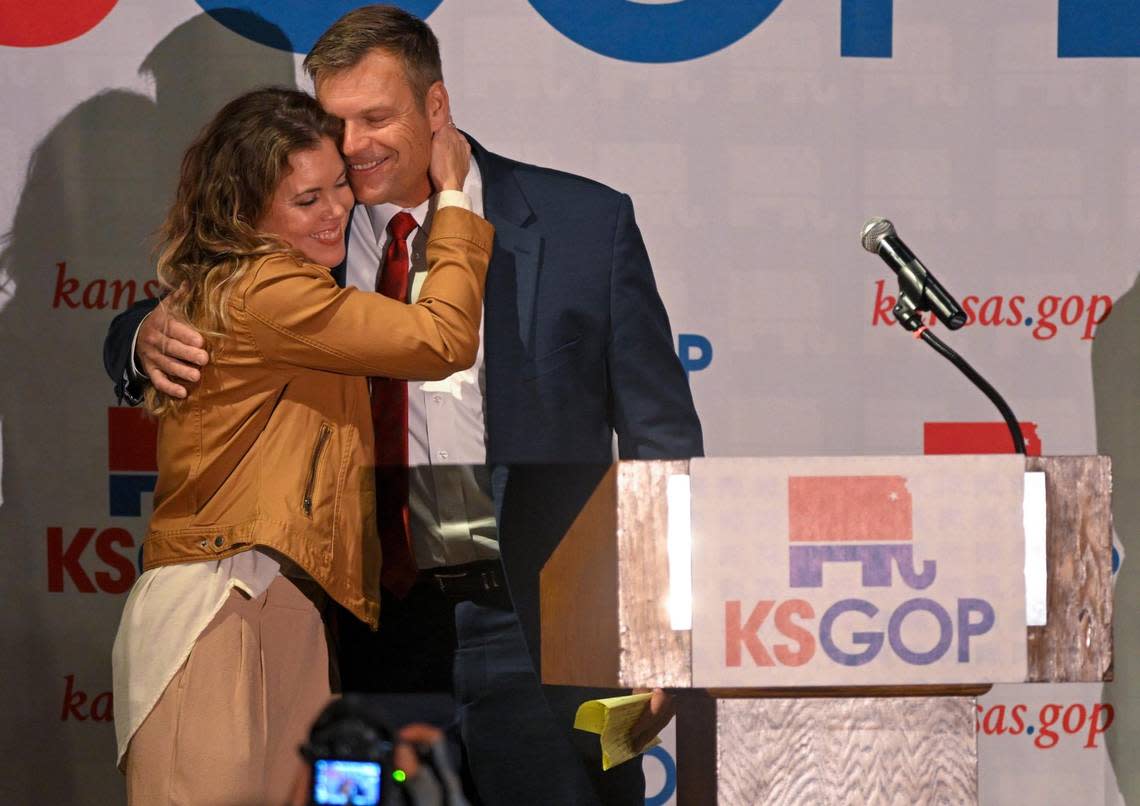 Republican Kris Kobach gets a hug from his wife, Heather, after he claimed victory in the race for Kansas attorney general. He addressed his supporters at a Republican watch party on Tuesday, Nov. 8, 2022, in Topeka, Kansas.