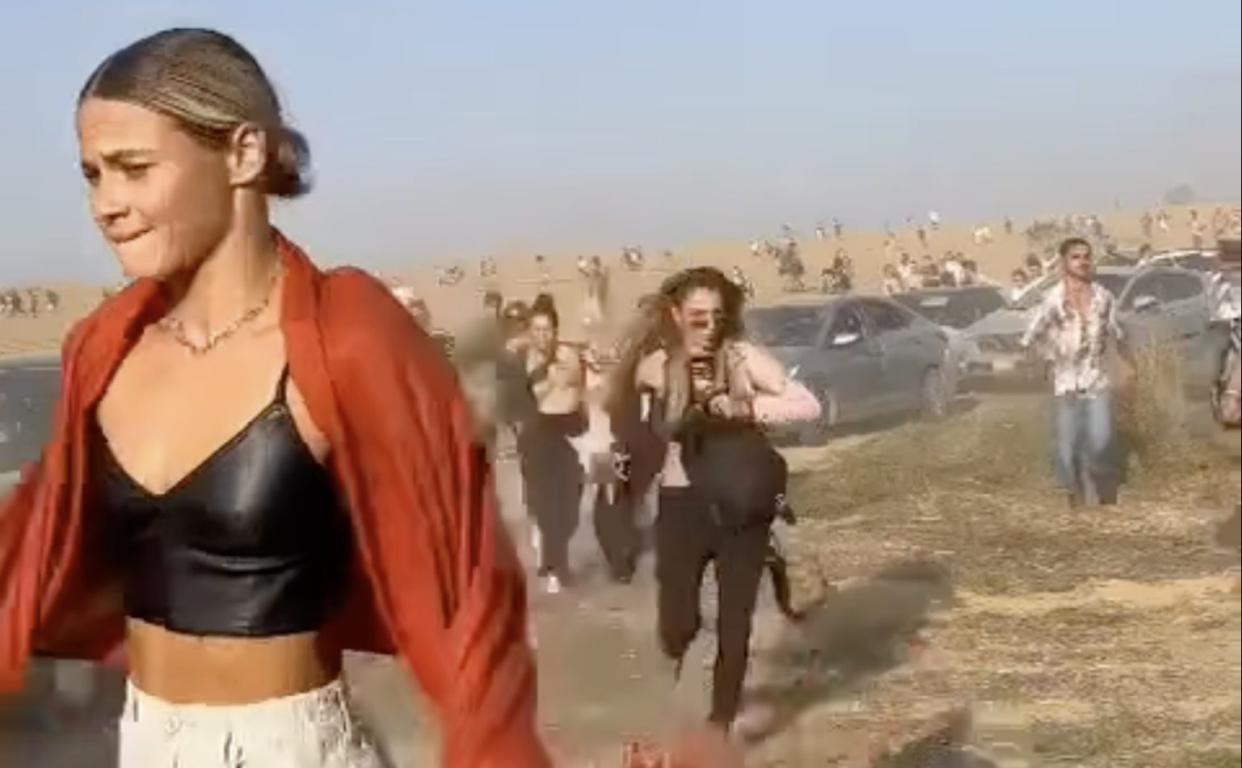 People flee a rave in Israel’s Negev Desert