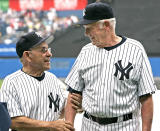 In this hand-out photo released by the New York Yankees, former Yankee Yogi Berra, left, talks with former teammate Don Larsen at the 60th Annual Old-Timer's Day duting MLB baseball at Yankee Stadium in New York. (AP Photo/NY Yankees,HO)