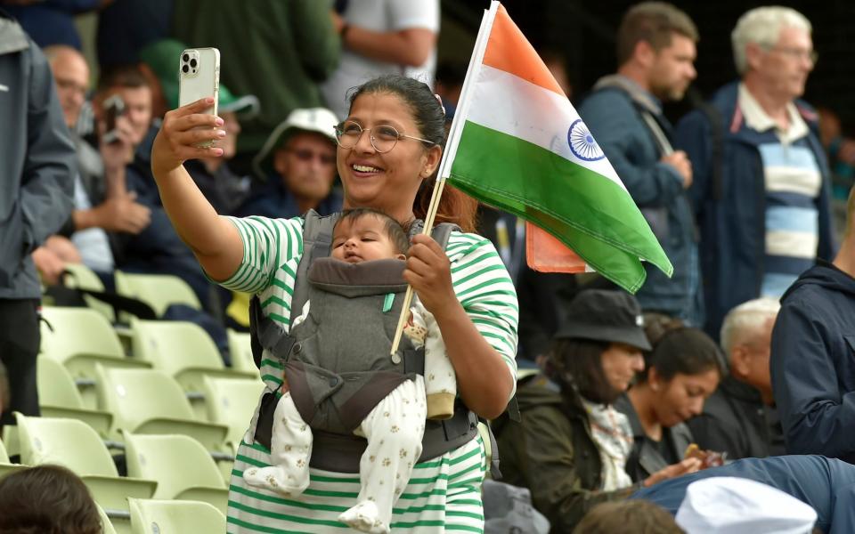 An Indian supporter takes a selfie with her child after rain stopped play during the first day of the fifth cricket test match between England and India at Edgbaston in Birmingham, England, Friday, July 1, 2022 - Rui Vieira/AP