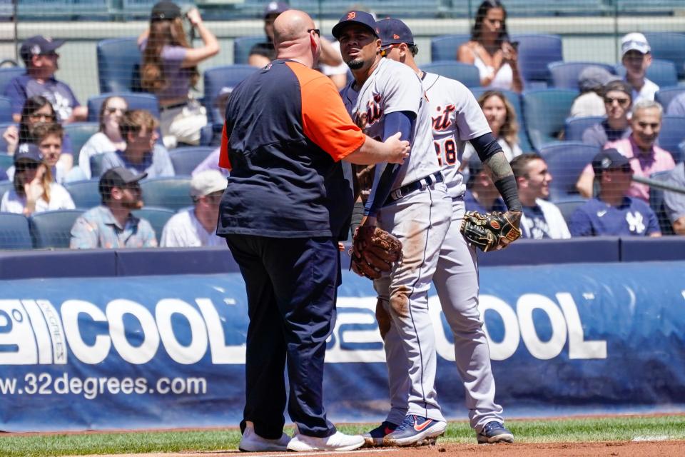 Tigers third baseman Jeimer Candelario, center, is helped off the field after an injury in the second inning against the Yankees, Sunday, June 5, 2022, in New York.