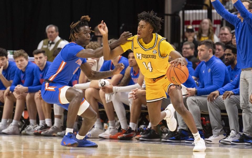 Missouri's Anthony Robinson II, right, tries to drive past Florida's Denzel Aberdeen during the first half of an NCAA college basketball game Saturday, Jan. 20, 2024, in Columbia, Mo. (AP Photo/L.G. Patterson)
