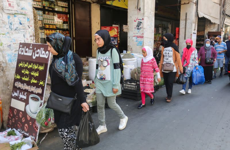 People walk along a street in Sidon