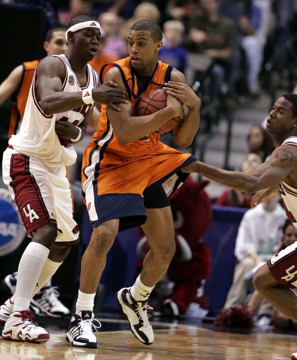 Bucknell guard Charles Lee, center, grabs a loose ball in front of Arkansas guard Ronnie Brewer, left, and guard Jonathon Modica, right, during the second half of their game in the  first round of the NCAA tournament in Dallas, Friday, March 17, 2006. Charles Lee scored 24-points in Bucknell's 59-55 win.