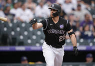 Colorado Rockies' C.J. Cron tosses his bat after hitting a grand slam off Milwaukee Brewers starting pitcher Brandon Woodruff during the first inning of a baseball game Thursday, June 17, 2021, in Denver. (AP Photo/David Zalubowski)