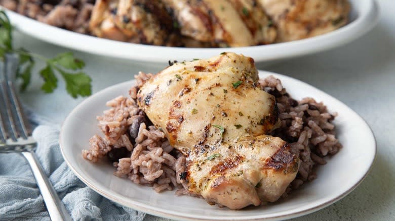 chicken with rice and beans on white plate