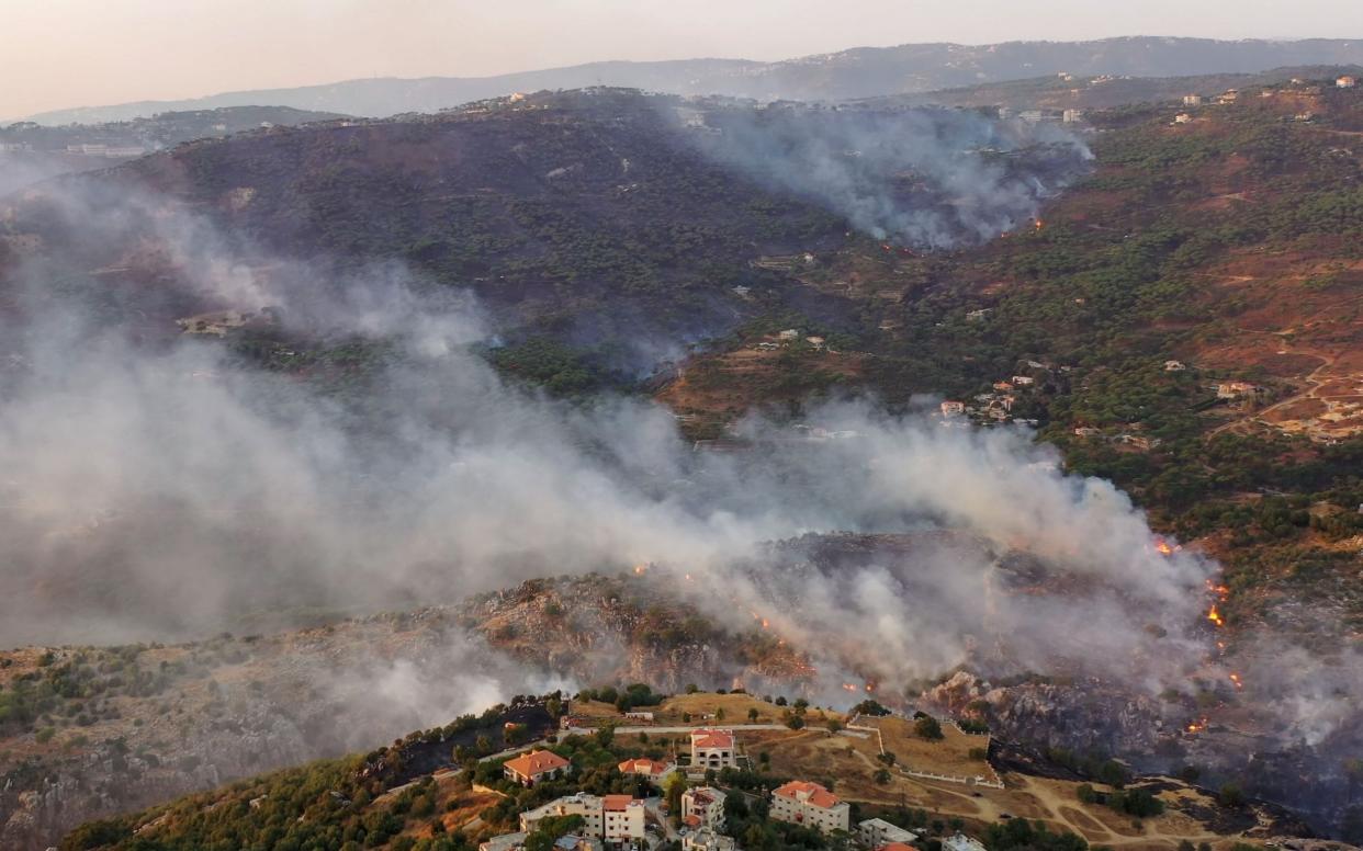 An aerial picture shows smoke billowing from a forest fire in Lebanon's Ras El Metn area - -/AFP