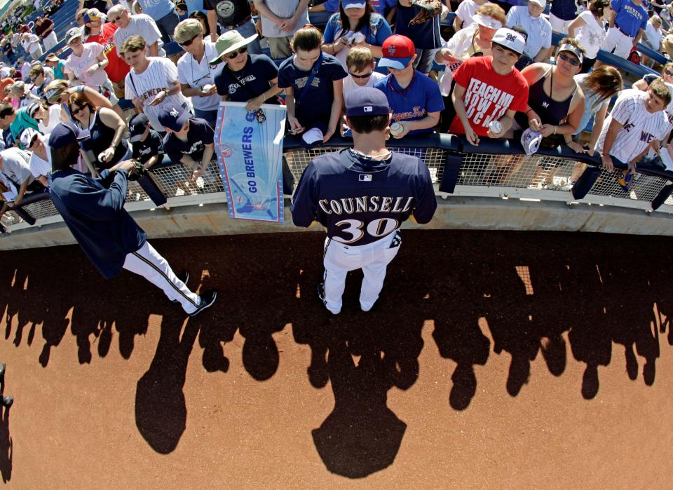 Milwaukee Brewers' Craig Counsell signs autographs before a spring training baseball game against the Chicago Cubs Wednesday, March 2, 2011, in Phoenix.
