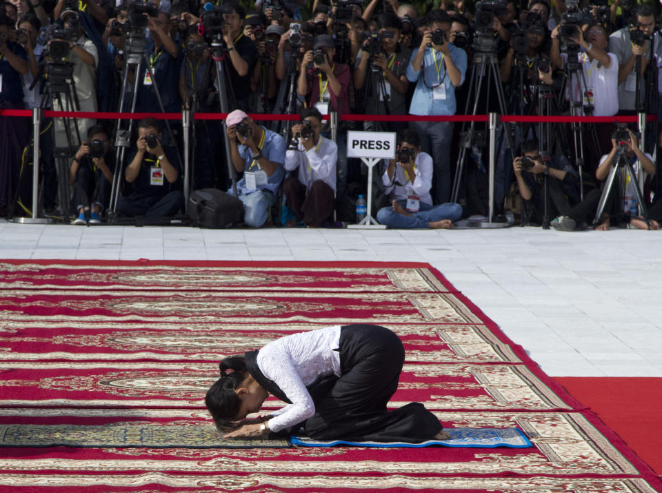 Myanmar leader Aung San Suu Kyi prays at the tomb of her late father and Myanmar's independence hero Gen. Aung San during a ceremony to mark the 72nd anniversary of his 1947 assassination, at the Martyrs' Mausoleum Friday, July 19, 2019, in Yangon, Myanmar. The country's Independence hero Gen. Aung San and his cabinet were gunned down in 1947. (AP Photo/Thein Zaw)