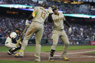 San Diego Padres' Juan Soto, right, is congratulated by Manny Machado (13) after hitting a home run during the fifth inning of a baseball game against the San Francisco Giants in San Francisco, Monday, June 19, 2023. (AP Photo/Jeff Chiu)