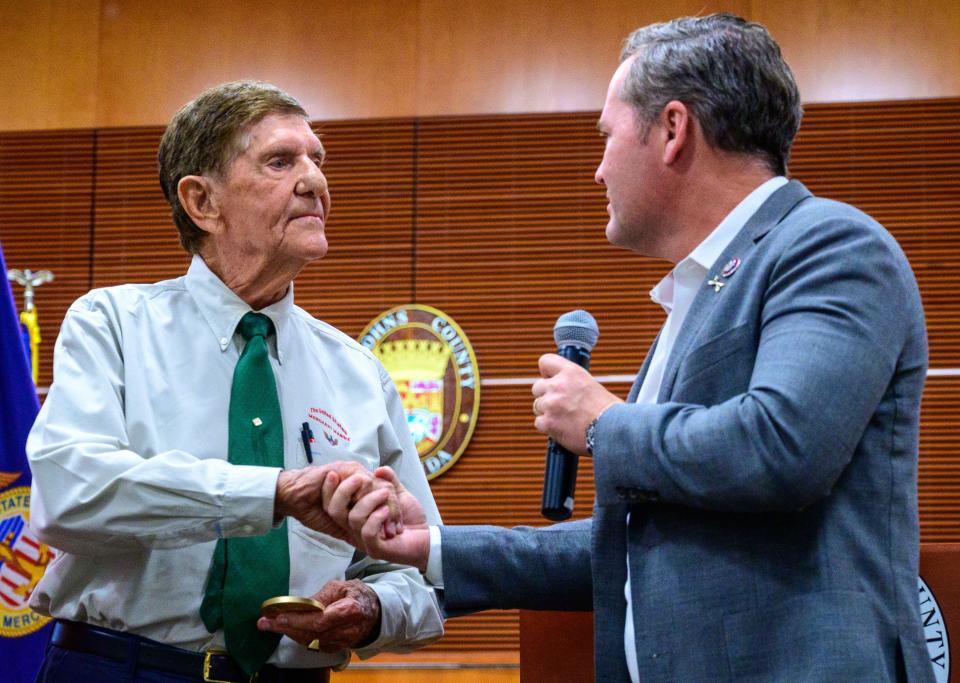 Ed Trester, 95, shakes hands with U.S. Congressman Mike Waltz after he presented him with a Congressional Gold Medal for his service in the U.S. Merchant Marine during World War II at a ceremony held at the St. Johns County Administration building in St. Augustine on Thursday, June 30, 2022.