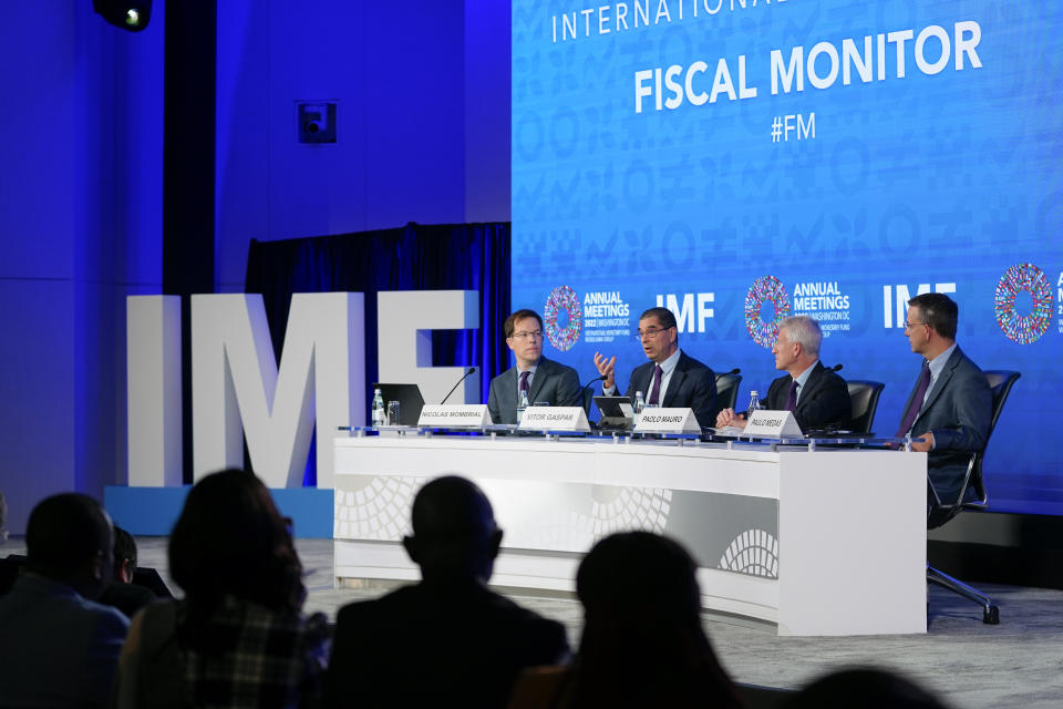 Vitor Gaspar, second from left, director of the Fiscal Affairs Department at the International Monetary Fund, speaks at a news conference during the 2022 annual meeting of the IMF and the World Bank Group, Wednesday, Oct. 12, 2022, in Washington. Seated with Gaspar are moderator Nicolas Mombrial, from left, Paolo Mauro, deputy director of the IMF's Fiscal Affairs Department, and Paulo Medas, assistant director of the IMF's Fiscal Affairs Department. (AP Photo/Patrick Semansky)