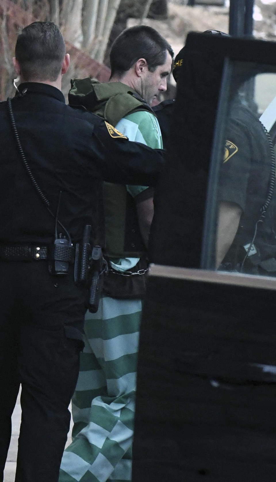 Patrick Frazee is escorted to an awaiting SUV after a hearing at the Teller County Courthouse in Cripple Creek, Colo., on Tuesday, Feb. 19, 2019. Following the daylong hearing, Teller County Judge Scott Sells found there is enough evidence for Frazee to stand trial for murder and other charges. He was arrested in Dec. 2018, about a month after Kelsey Berreth, 29, was last seen alive on Thanksgiving Day. Frazee and the victim, Berreth, have an infant daughter together. (Jerilee Bennett/The Gazette via AP)