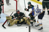 St. Louis Blues' Ryan O'Reilly (90) works against Minnesota Wild's Kevin Fiala (22) for the puck in front of Wild goalie Marc-Andre Fleury during the third period of Game 2 of an NHL hockey Stanley Cup first-round playoff series Wednesday, May 4, 2022, in St. Paul, Minn. The Wild won 6-2. (AP Photo/Jim Mone)