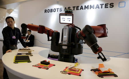 A Baxter robot of Rethink Robotics picks up a business card as it performs during a display at the World Economic Forum (WEF), in China's port city Dalian, Liaoning province, China, September 9, 2015. REUTERS/Jason Lee