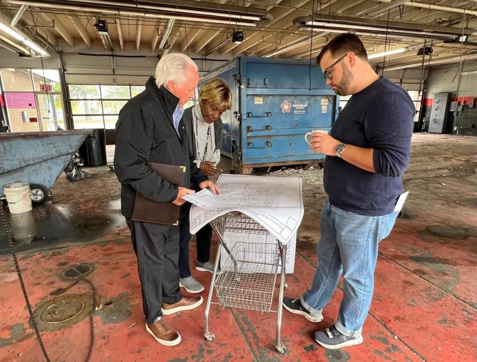 From left, Ted Swaldo, Betty Smith and Mike Scott review plans for renovations to the former Ziegler Tire building in downtown Canton. The building will become the permanent home of the EN-RICH-MENT Fine Arts Academy. A fundraising campaign is being launched for the project.