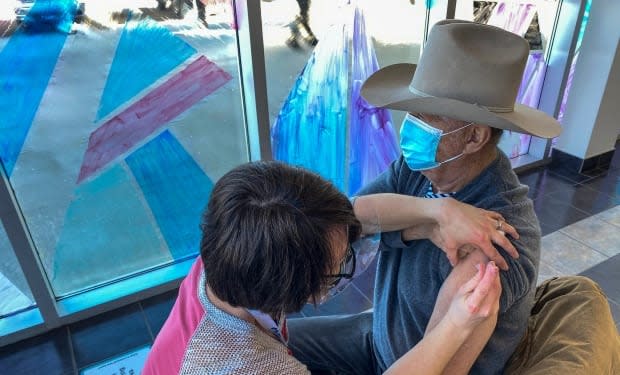 Allan Pasutto, 86, of Penhold, Alberta gets the COVID-19 vaccine in Red Deer.