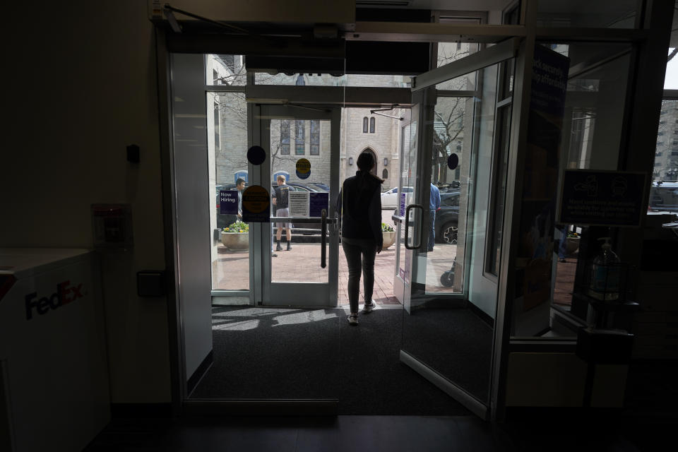 Mikela Earley leaves a business with an order for a customer who is inside of the bubble while in town for the NCAA men's college basketball tournament, Tuesday, March 30, 2021, in Indianapolis. The NCAA and local organizing groups set up expanded ambassador and item-delivery services relying on volunteer help to take care of needs for players, officials and others working inside. (AP Photo/Darron Cummings)