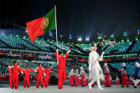 <p>Flag bearer Kequyen Lam of Portugal and teammates during the Opening Ceremony of the PyeongChang 2018 Winter Olympic Games at PyeongChang Olympic Stadium on February 9, 2018 in Pyeongchang-gun, South Korea. (Photo by Matthias Hangst/Getty Images) </p>