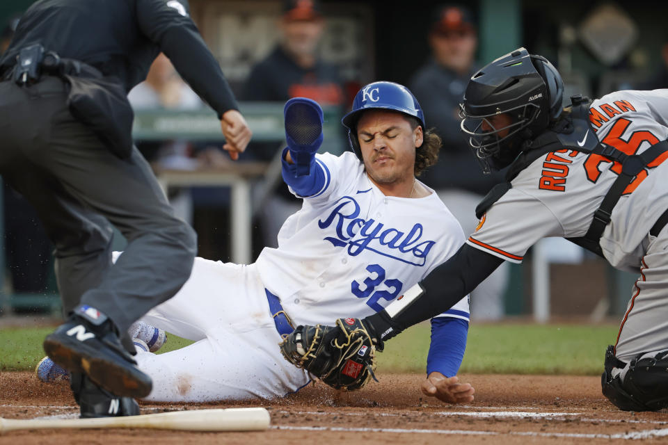 Kansas City Royals' Nick Pratto (32) is tagged out at home plate by Baltimore Orioles catcher Adley Rutschman (35) after attempting to score from second off a hit to the outfield during the second inning of a baseball game in Kansas City, Mo., Wednesday, May 3, 2023. (AP Photo/Colin E. Braley)