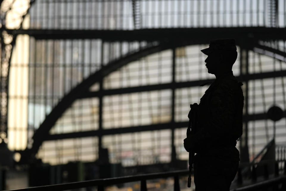 A soldier guards the old Mapocho train station, now a cultural center, as it is prepared to be a polling station for the Constitutional Council election in Santiago, Chile, Friday, May 5, 2023. The election will be held May 7, after a first attempt to replace the current Constitution bequeathed by the military 42 years ago was rejected by voters in 2022. (AP Photo/Esteban Felix)