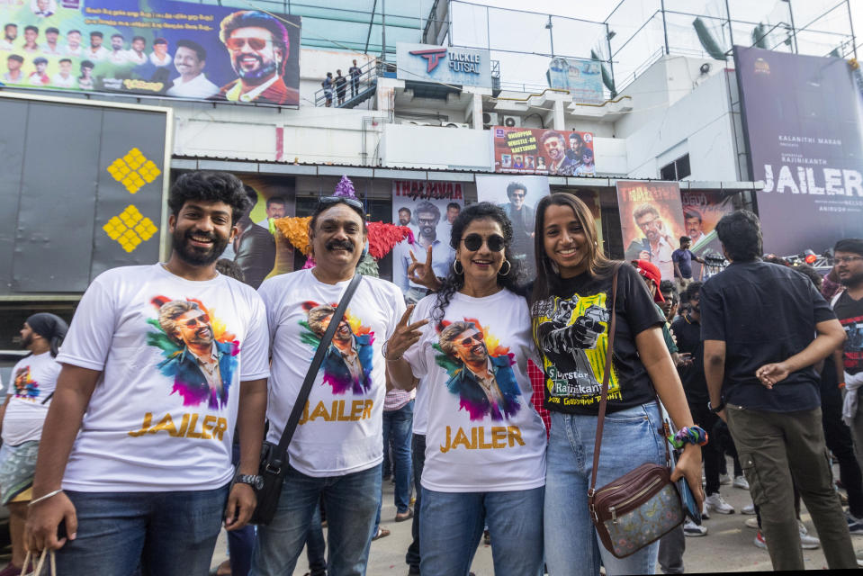 Fans of Indian superstar Rajinikanth, cheer as they arrive to watch the screening of his latest film "Jailer" in Chennai, India, Thursday, Aug. 10, 2023. (AP Photo/ R. Parthibhan)