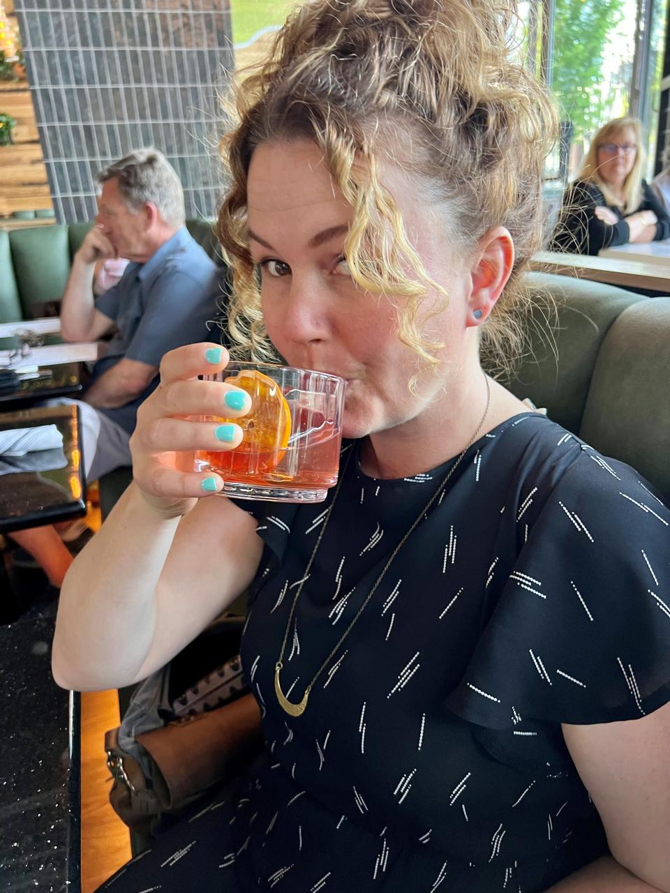 Tennessean food writer Mackensy Lunsford with an old fashioned at the Hand Cut Chophouse in the downtown Embassy Suites in Nashville on April 18, 2023