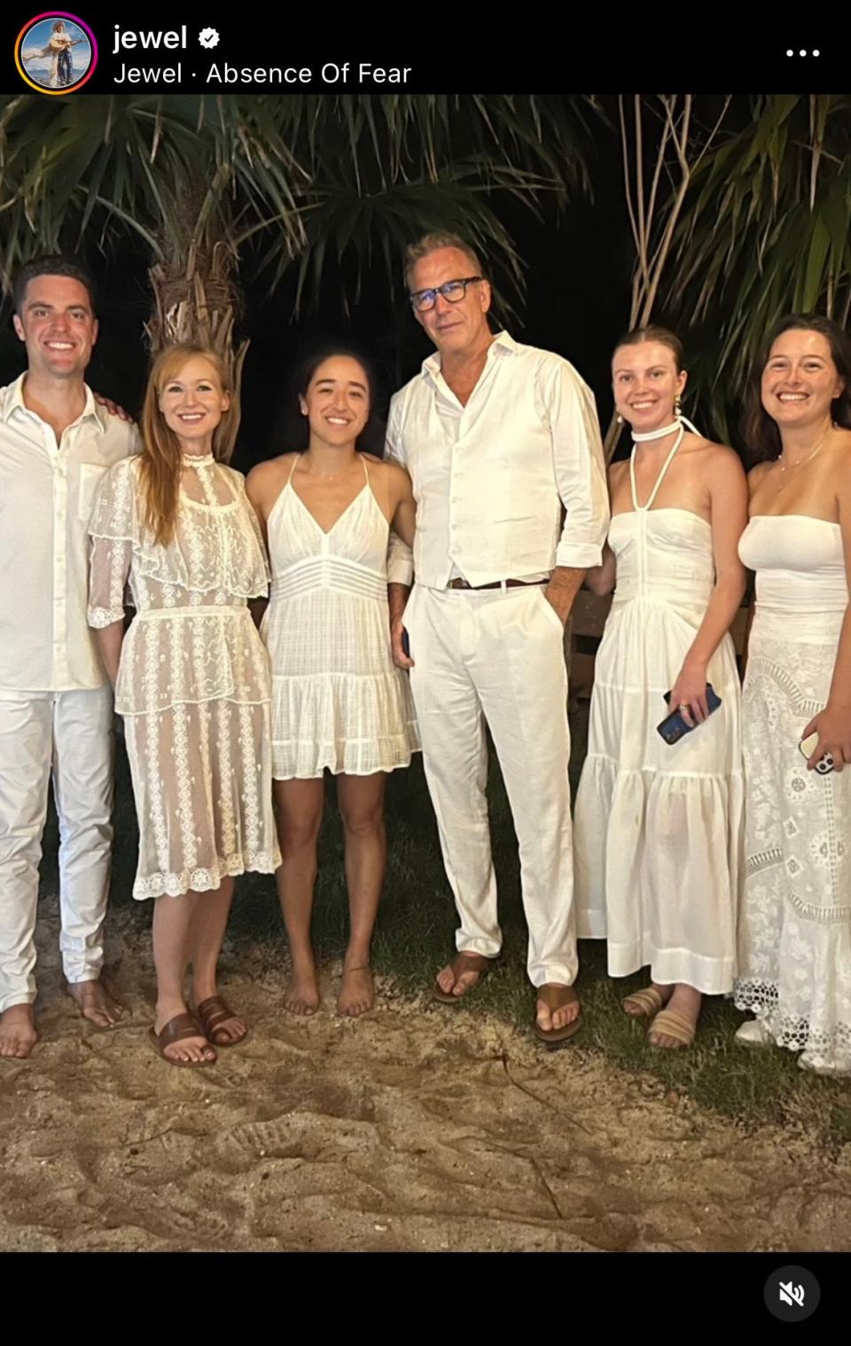 Group photo of Jewel and Kevin Costner with others all wearing white