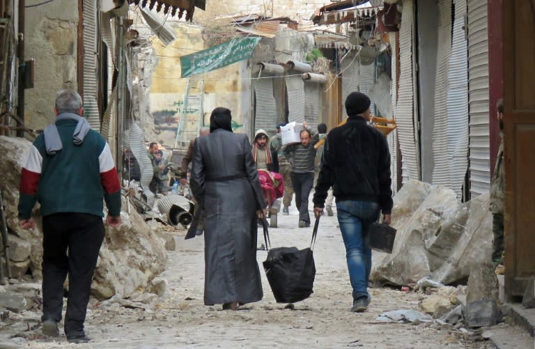 Syrians walk in the old market in the government-held old city of Aleppo