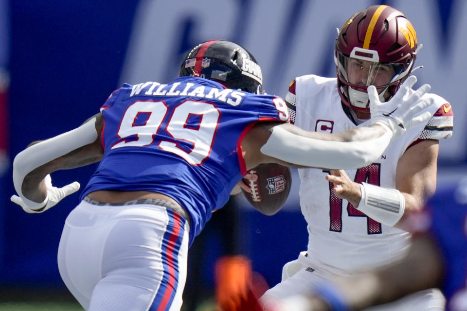 New York Giants defensive end Leonard Williams (99) sacks Washington Commanders quarterback Sam Howell (14) during the first quarter an NFL football game, Sunday, Oct. 22, 2023, in East Rutherford, N.J. (AP Photo/Seth Wenig)