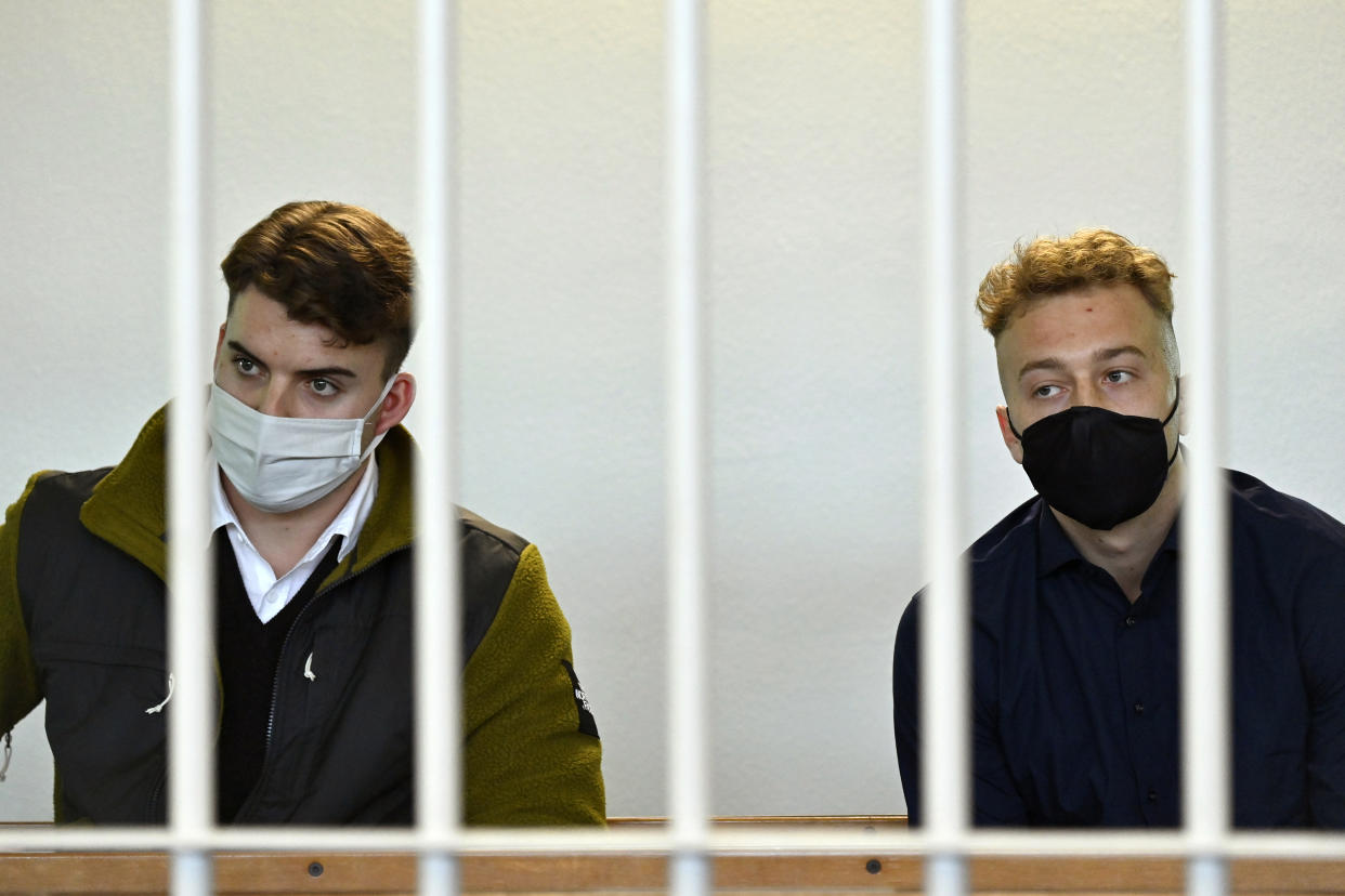 Gabriel Natale-Hjorth, left, and Finnegan Lee Elder, both from the U.S., wear face masks to curb the spread of COVID-19 as they sit bars inside the courtroom during a break in a hearing in the trial where they are accused of slaying a plainclothes Carabinieri officer in July 2019, in Rome. (Alberto Pizzoli/Pool Photo via AP)