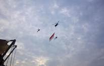 Everyone was surprised to see the Singapore flag making its way across the sky, as part of the National Day Parade rehearsals. (Yahoo! photo/Melissa Law)