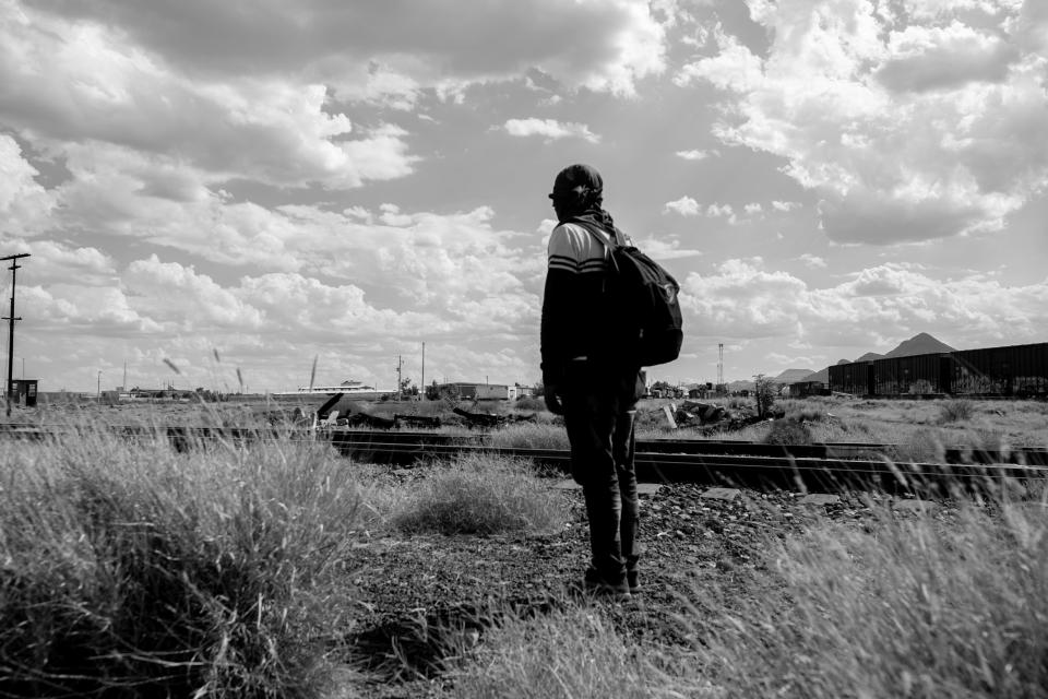 A migrant observes Mexican National Guard soldiers as they approach a large group of migrants at a rail yard in Chihuahua City, Mexico on Sept. 23, 2023.